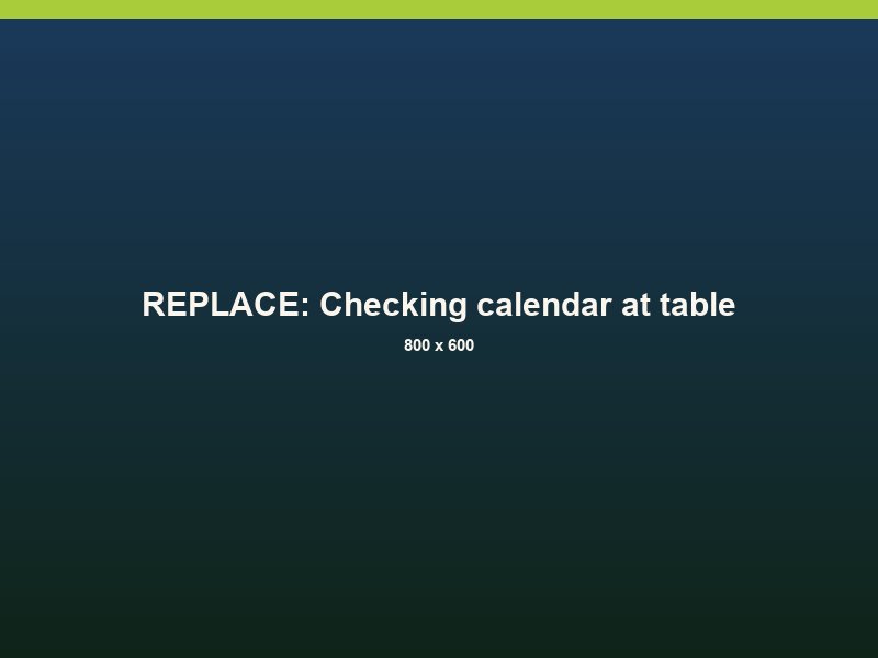 A person checking a calendar on a phone at a kitchen table